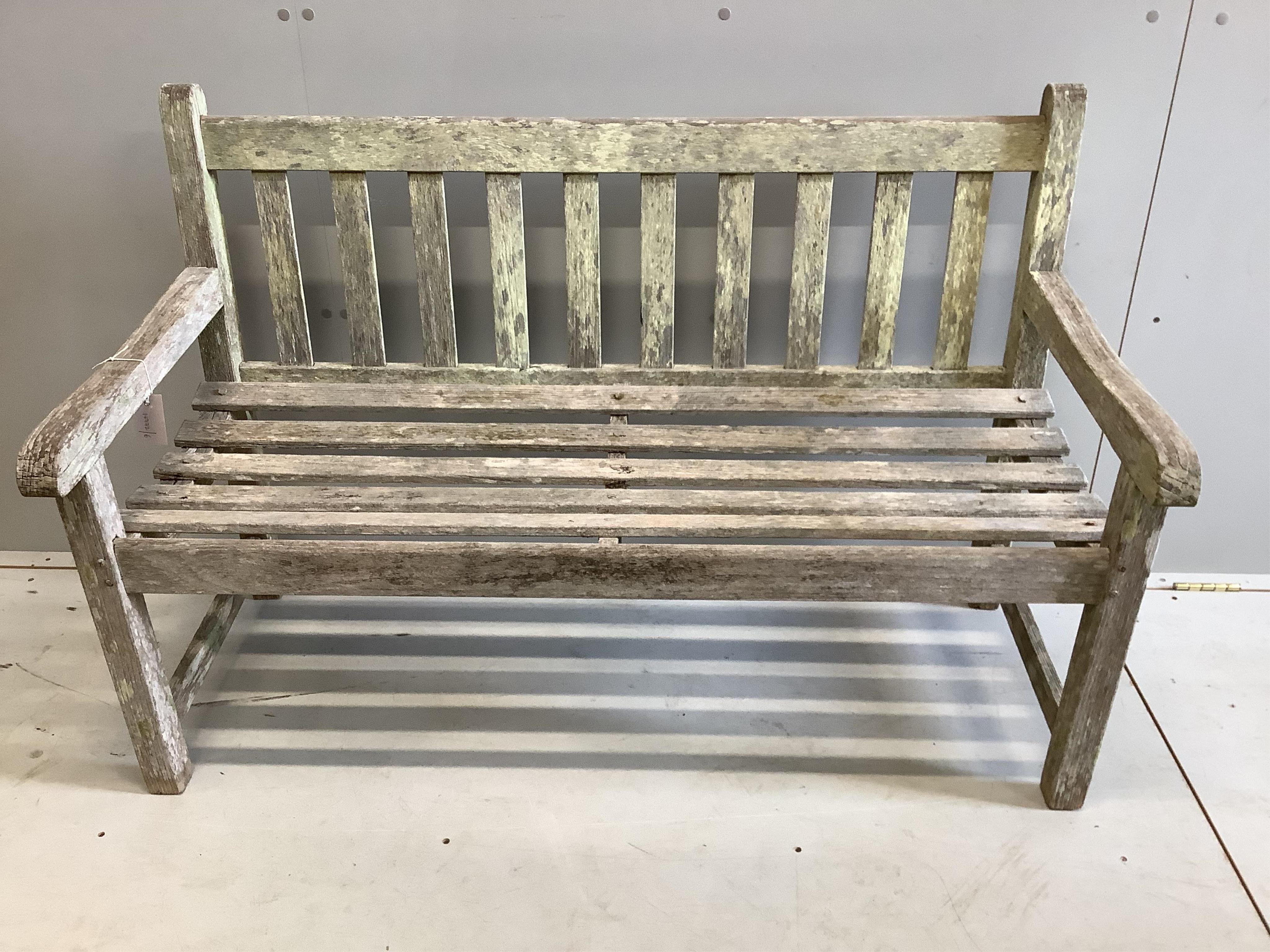 A weathered teak garden bench, width 121cm, depth 56cm, height 82cm. Condition - fair